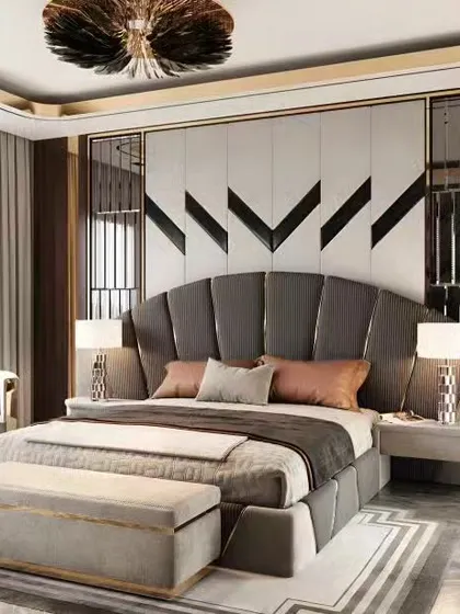 This bedroom exudes art deco glamour with a fan-shaped upholstered headboard and metallic accents. The design is bold and luxurious, perfect for a statement master suite.