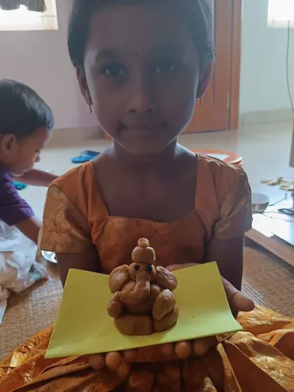 A child's finished clay Ganesha, ready for the celebration. The act of sculpting develops fine motor skills and patience.