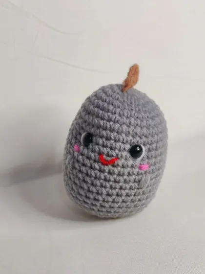 The front view of the little grey dino.