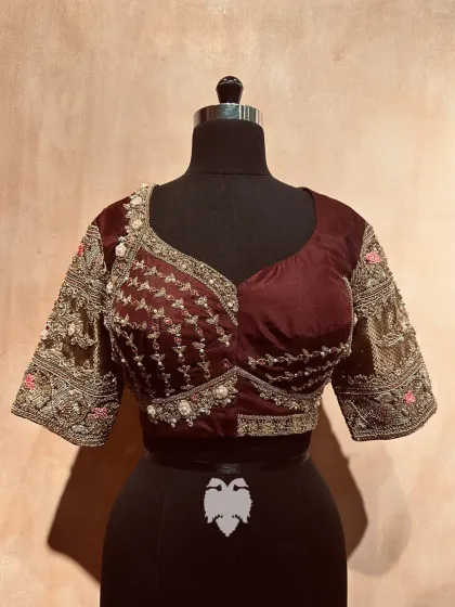 The front view of the brown silk blouse, with its jewel-style sleeve armlet.