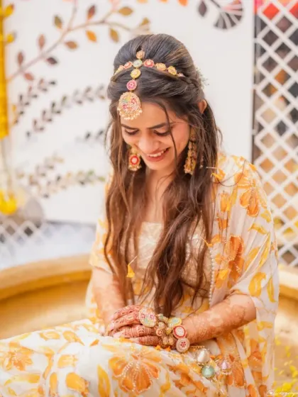 The bride looking radiant and happy, adorned with beautiful floral jewelry for her Haldi ceremony. I help you coordinate all the details for a perfect look.