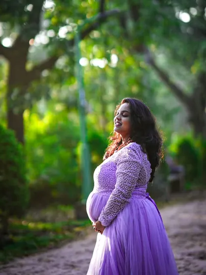 A serene moment during a maternity shoot. The soft lighting highlights her pregnancy glow, which I enhanced with a natural and radiant makeup application.