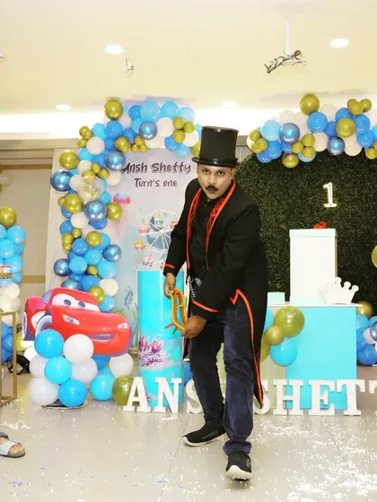 A dynamic pose during the linking rings routine. I bring a lot of energy and showmanship to every performance to keep the party atmosphere going.