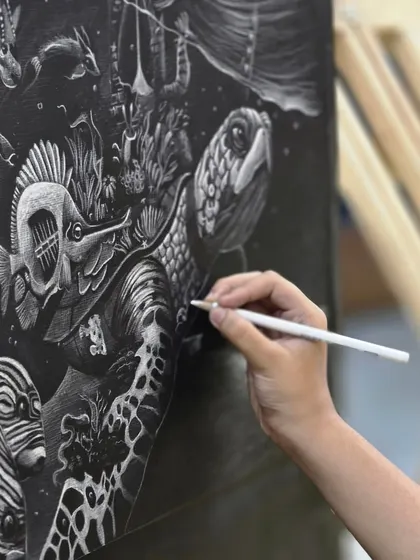 This macro shot highlights the fine lines and textures created with a white pencil, demonstrating how the artist rendered the turtle's skin and the fish's scales.
