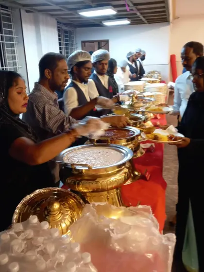 Our staff stands ready at a fully arranged buffet line at SSR Function Hall. We use traditional golden serving dishes to add a touch of class to the wedding feast, ensuring food is kept warm and served professionally.