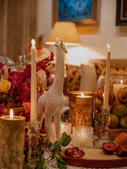 A playful white giraffe figurine adds a touch of whimsy to the elegant tablescape. We believe in incorporating personal and unexpected details to make each event unique.