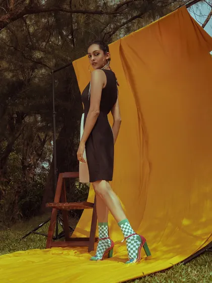 A back view of the 'ELINOR' look, showing the color-blocked design of the dress.
