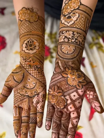 This design shows a mix of styles, with one hand featuring a lotus centerpiece and the other a dense floral and jaal pattern, showcasing my versatility.