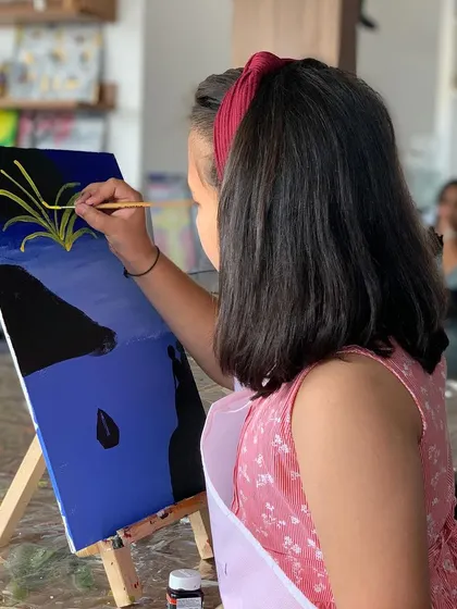 A young girl carefully painting her canvas at our Bangalore studio. We love seeing the next generation of artists at work.