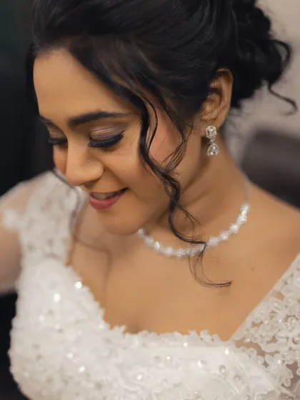 A close-up of Steffi's makeup and hairstyle. The soft curls framing her face add a touch of romance to the look.