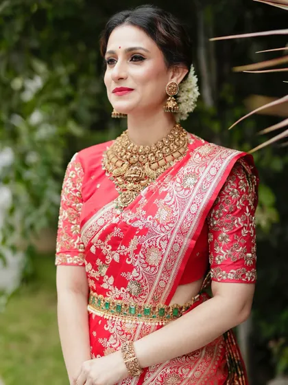 A beautiful portrait showcasing the rich texture of the Banarasi silk and the craftsmanship of the hand-embroidered blouse.