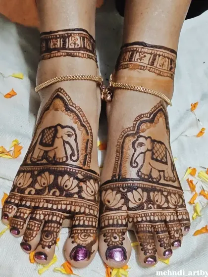 For a truly grand look, I create full coverage foot mehendi. This design features majestic elephants framed by architectural patterns, extending from the toes to the ankles for a complete bridal or festive style.