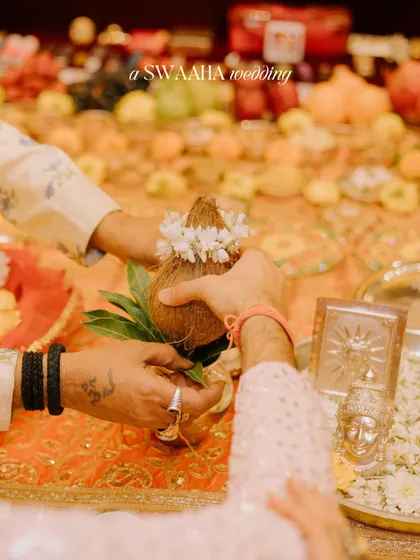 A close-up of the coconut ritual, a significant part of many Hindu wedding ceremonies.