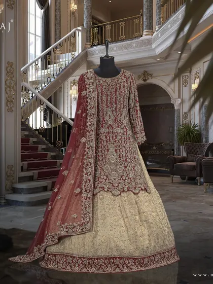 A side view of the maroon scalloped long top and gold banarsi lehenga, a perfect example of Pakistani fashion inspiration.