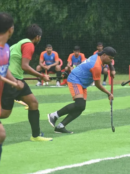 A player dribbles the ball down the line, supported by his teammates. This image shows our focus on teamwork and maintaining possession.