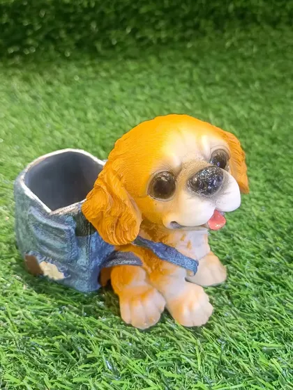 This cute dog pen holder, resembling a Cocker Spaniel, is a great way to keep your study table tidy. It's crafted with lovely detail and is a perfect gift.