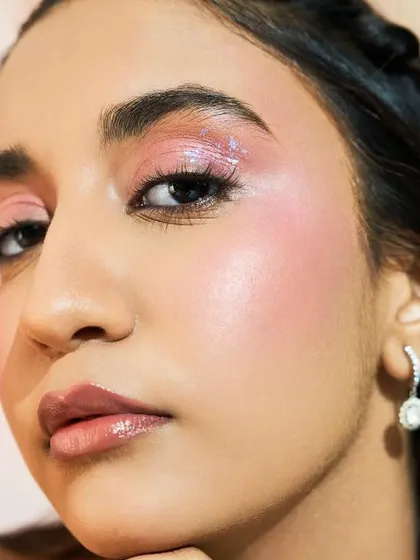 The light catches the shimmer on the cheeks, creating a magical, ethereal effect.