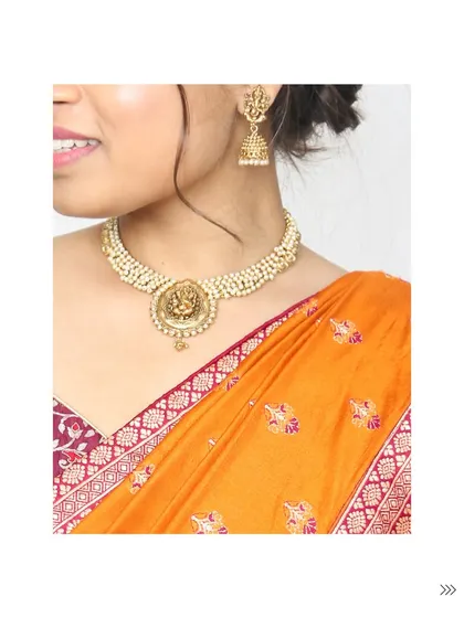 Don't forget the jewelry. This traditional temple jewelry necklace is the perfect accessory to rent alongside a classic lehenga like this one.