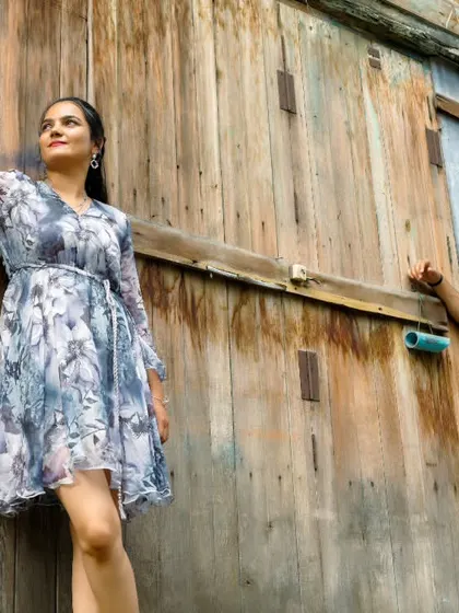 A stylish, posed shot against a rustic wooden wall, showing how we can find unique textures and backdrops even in a bustling location.
