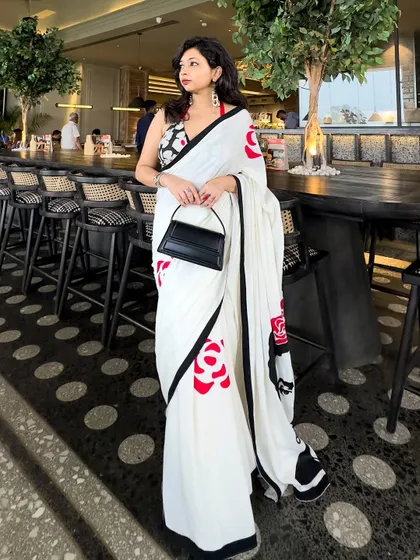 A modern saree look perfect for a special date night or a chic lunch. I believe in creating outfits that are memorable, combining unique pieces like this hand-painted saree with a contemporary halter-neck blouse and a structured bag for that clean, crisp, and confident vibe.