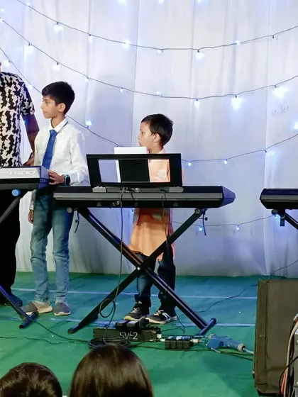 Our students performing as a keyboard ensemble on stage. Group performances teach valuable lessons in timing, listening, and collaboration.