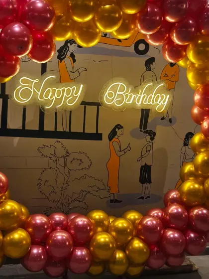 We create sophisticated and stylish atmospheres for adult celebrations. This birthday setup at The Bier Library in Koramangala features a chic balloon ring and neon sign, perfectly complementing the venue's modern and ambient vibe for a memorable night.