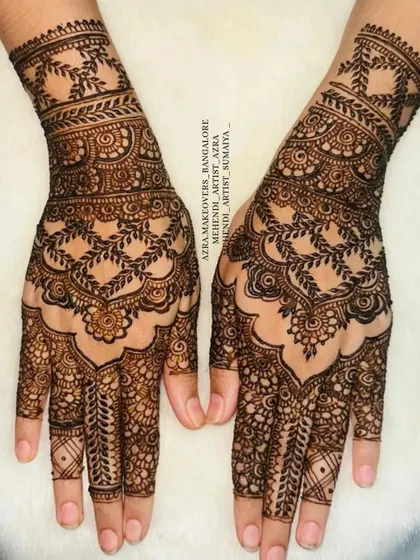 A beautiful non-bridal design with leafy vines and intricate patterns on the back of the hand.