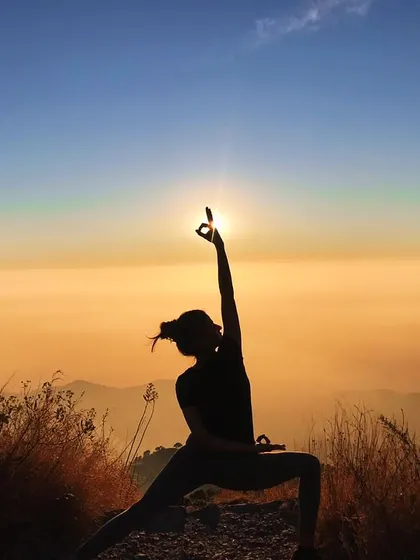 The Gyan mudra in this Reverse Warrior pose signifies knowledge and concentration. Practicing it against the backdrop of a Himalayan sunset helps to focus the mind and absorb the wisdom of the mountains.