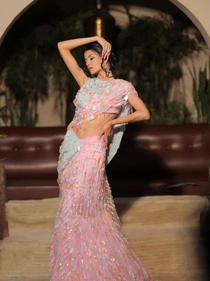 The full look is a pastel dream. The colourful eye makeup perfectly complements the iridescent, sequined saree.