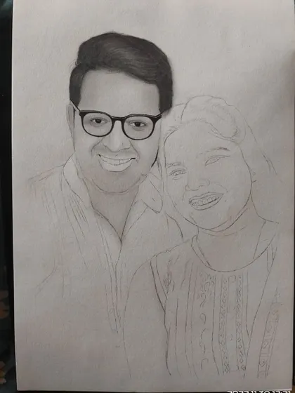 Here, the man's face is shaded, but the woman's portrait is still a light outline. This shows how I build up the drawing one section at a time.