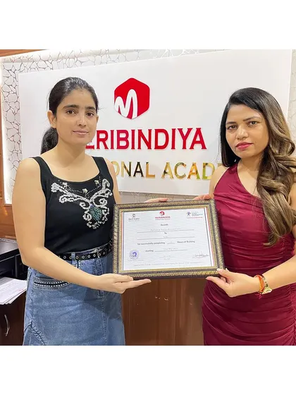 A happy student receives her certificate, a reward for her dedication and passion.
