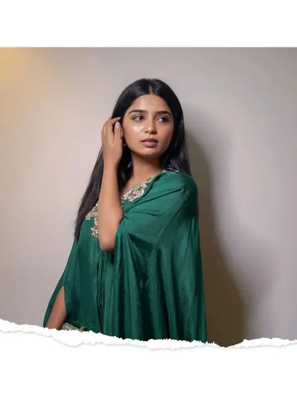 A beautiful portrait of Gouri in a stunning green kaftan, looking elegant and poised.