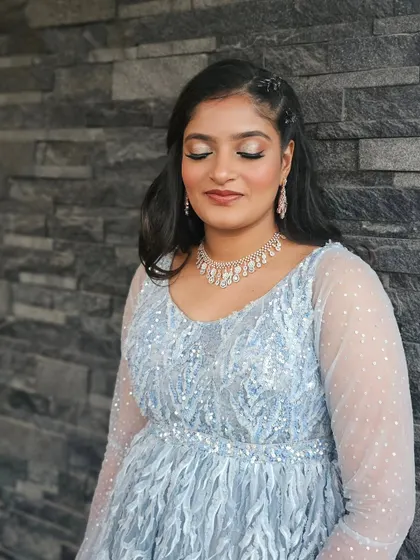 A close-up of the glittery eye makeup and soft, wavy hair.