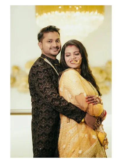 A warm and affectionate portrait of the couple in a close embrace. Their smiles and comfortable posture show their deep connection.