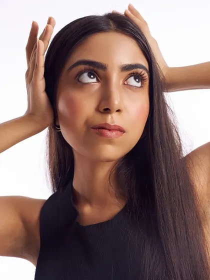 This image captures a fresh and youthful glow. The makeup is barely there, intended only to even out the skin tone and add a touch of color to the cheeks and lips for a healthy, vibrant look.