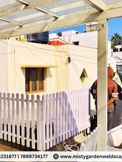 A traditional wooden picket fence adds charm and structure to any garden. Here, our team is installing one as part of a larger terrace beautification project.