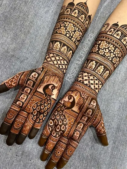 Graceful peacocks are the centerpiece of this elegant engagement mehndi. The fine lines and detailed feather work create a sense of movement and beauty, perfect for a bride-to-be.