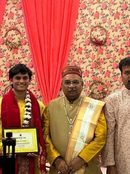 A group photo with a young artist after his performance, surrounded by senior musicians and gurus.