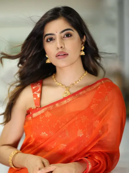 A confident and striking portrait of Amritha Aiyer, her makeup looking fresh and modern.