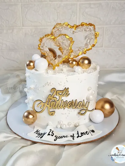 Twenty five years of love is a milestone worth celebrating in style. I made this elegant cake with edible crystal hearts and a '25th Anniversary' topper for an intimate silver jubilee party.