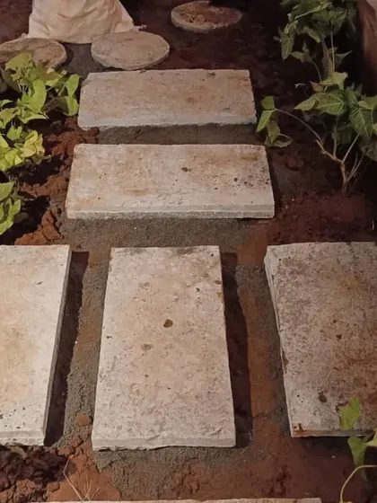 Laying the foundation for a stone pathway. Each stone is carefully placed to ensure the path is stable and even.