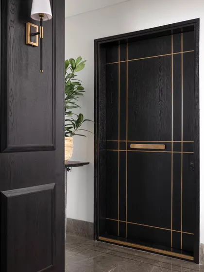 Another view of the stunning main door, a piece of custom craftsmanship that makes a powerful first impression.