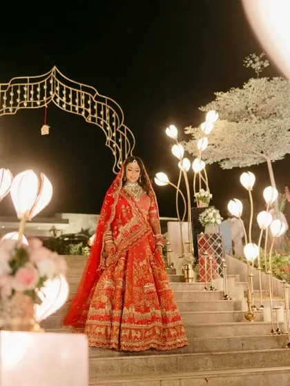 The bride poses on the staircase, framed by the unique illuminated props.