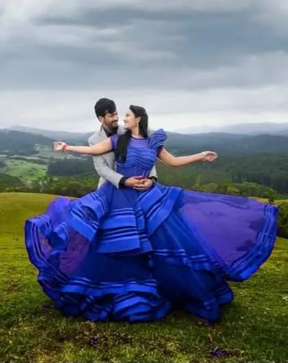 A breathtaking shot from a photoshoot in the hills. I styled the couple in this unique, structured royal blue gown and a grey suit, creating a cinematic look against the vast landscape.