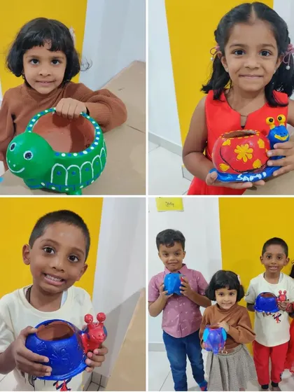 Four happy children posing with the colorful animal planters they painted during Aadvik's 5th birthday party.