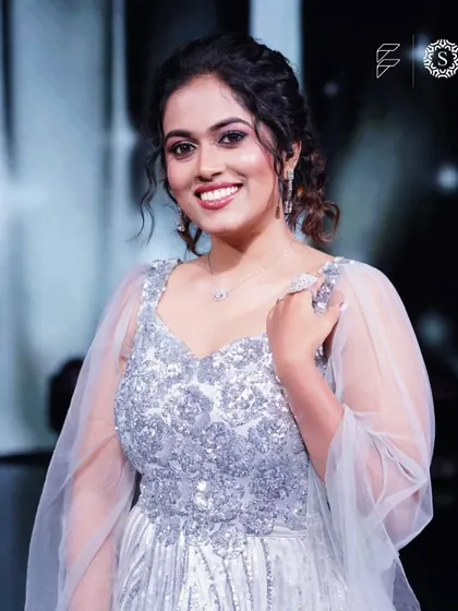 All smiles from singer Sayli Kamble. She looks elegant and happy in this silver gown and delicate jewelry from our rental collection.