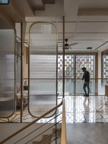 In the Screen House, strategically placed louvers and screens provide privacy without compromising openness. This view from the lounge shows how the design fosters a seamless flow between spaces.