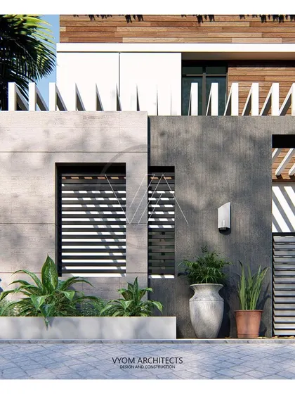 Detail of the external compound wall for the residence shown in image 57. The design of the boundary wall is an extension of the main house, using similar materials and forms to create a cohesive look.