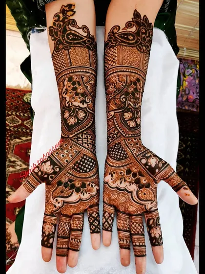 An example of dense, intricate pattern work. This design uses negative space and fine lines to create a captivating look with paisley and floral motifs.