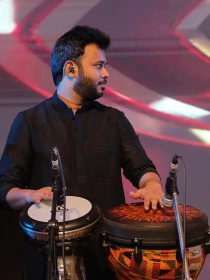 Focused on the rhythm during a live performance. My instruments, the Djembe and Darbuka, are chosen for their ability to produce a wide range of tones suitable for Sufi music.